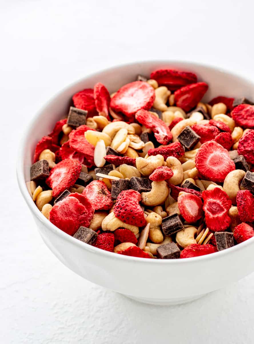 Healthy trail mix served in a white bowl.