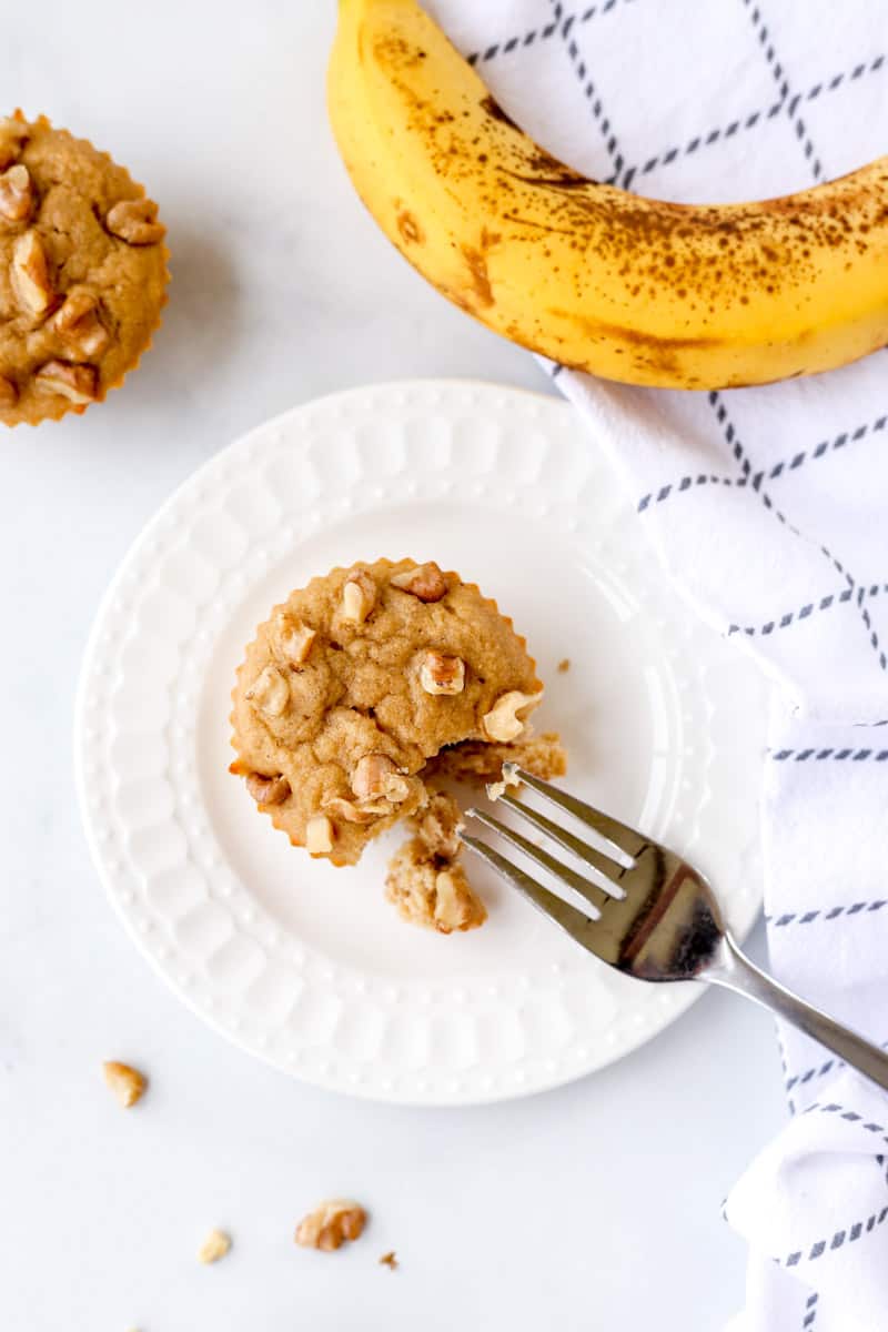 A banana walnut muffin being eaten with a fork.