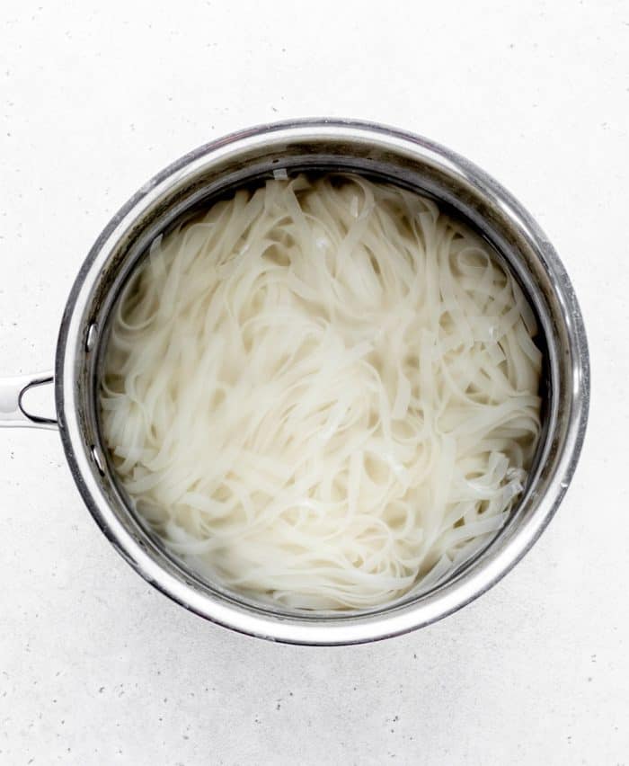 Cooked rice noodles in a pot.