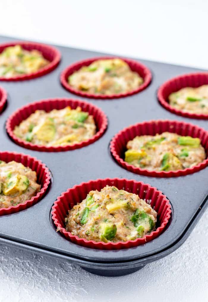 Baked chicken avocado poppers in a muffin tin.