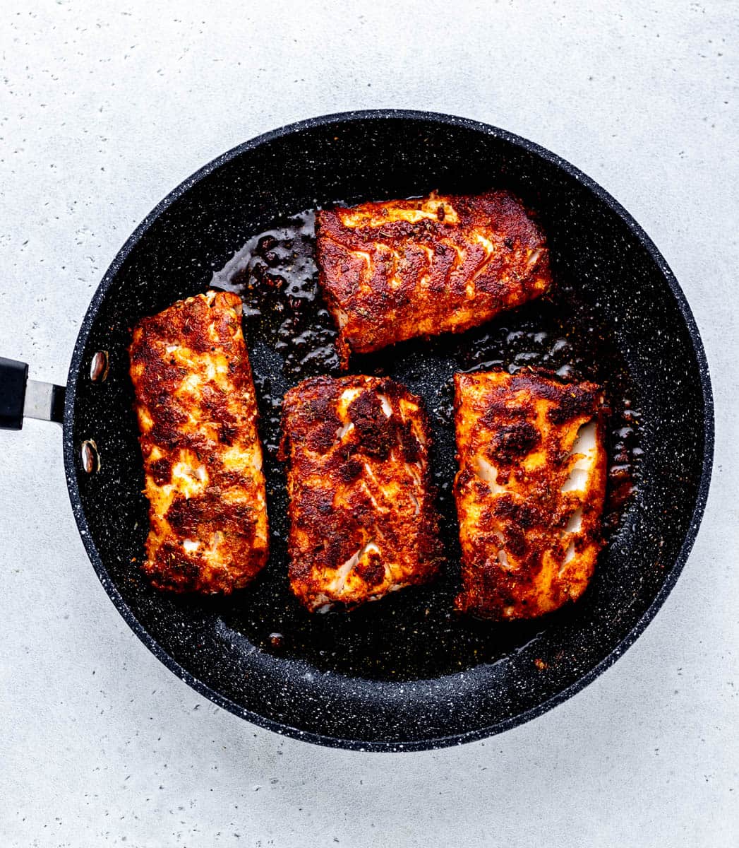 Cooking the cod in a cast iron skillet.