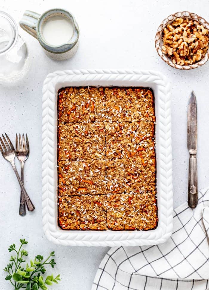 Baked carrot cake oatmeal in a white baking dish.
