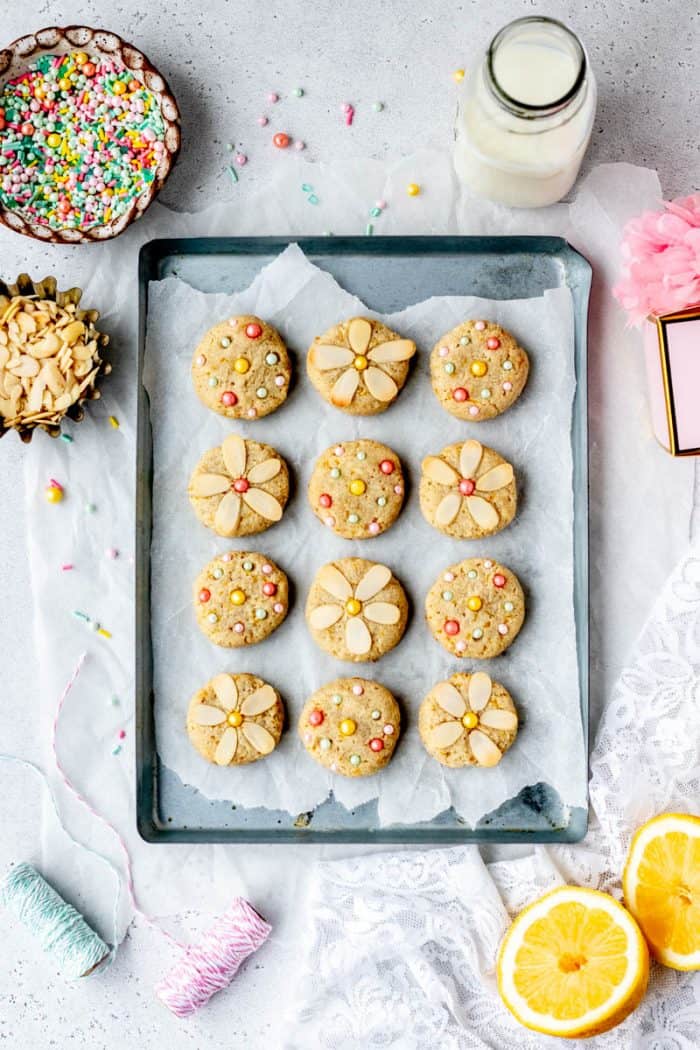 Twelve lemon cookies on a baking sheet.