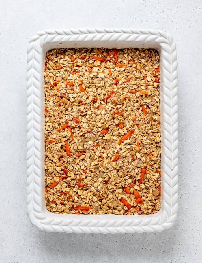 The oatmeal mixture spread in a baking dish.