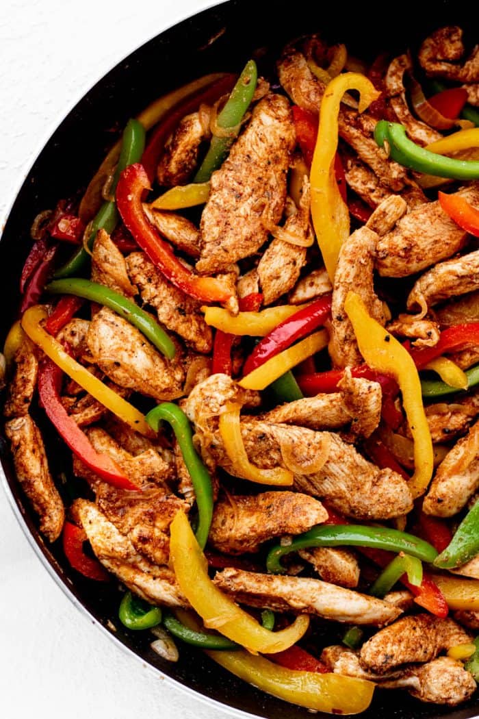 Overhead shot of Mexican chicken fajita and pepper mixture in a skillet.