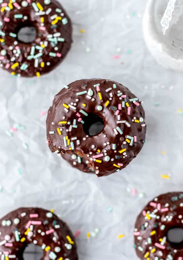 Baked donuts decorated with glaze and sprinkles.