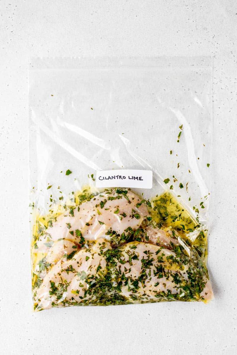 Cilantro lime chicken being marinated in freezer bag with label.