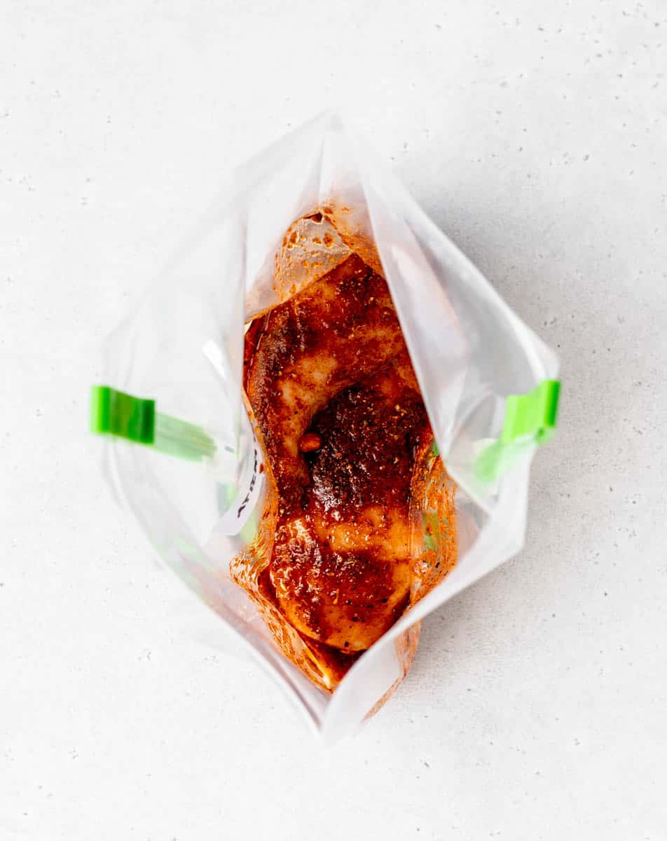 Mexican chicken marinade in a freezer bag on clips.