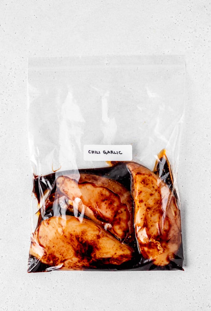 Chili garlic chicken in freezer bag with label.