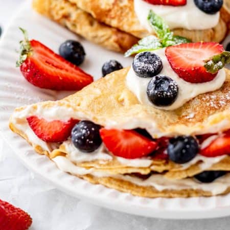 Almond milk crepes loaded with fresh berries and yogurt.