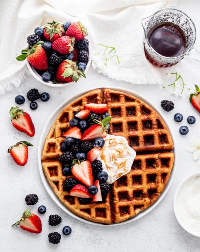 Oatmeal waffles topped with berries and yogurt.