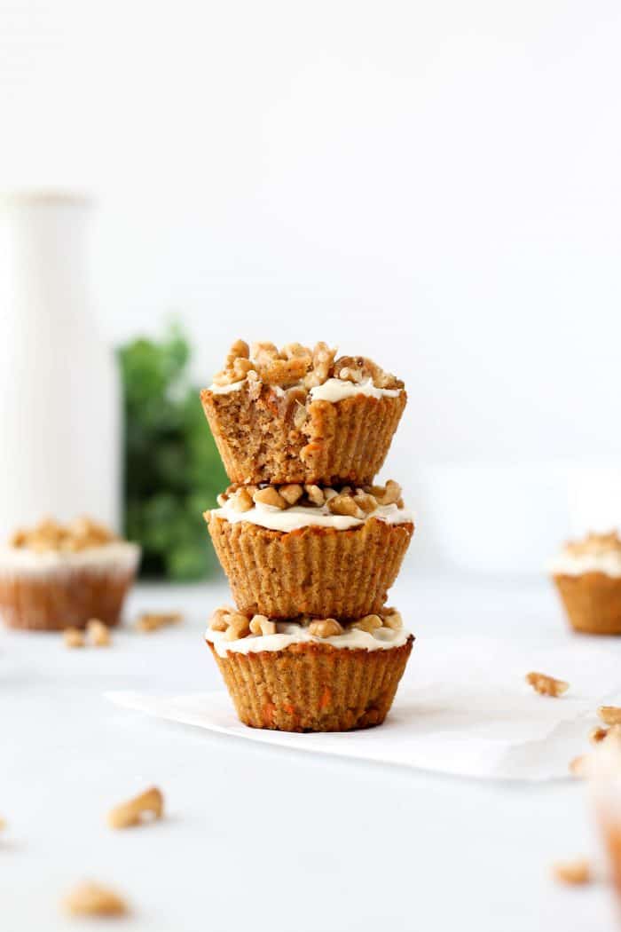 Three carrot pineapple muffins stacked on top of each other.