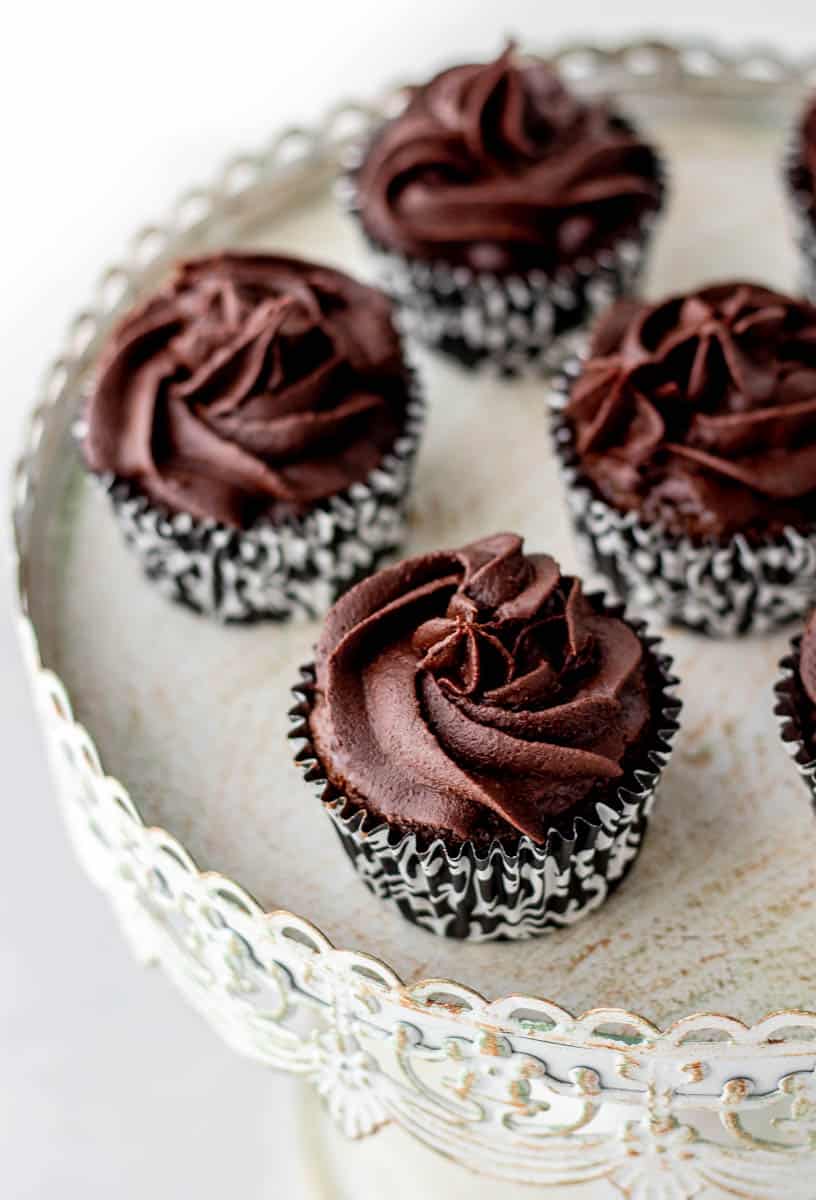 Close up of chocolate frosting on cupcakes.