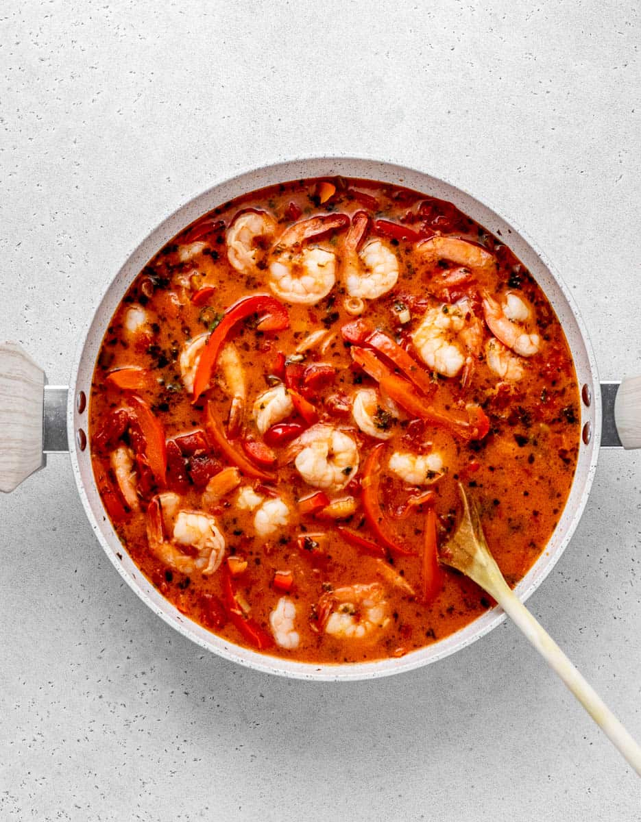 Shrimp added to the skillet with creamy coconut sauce.