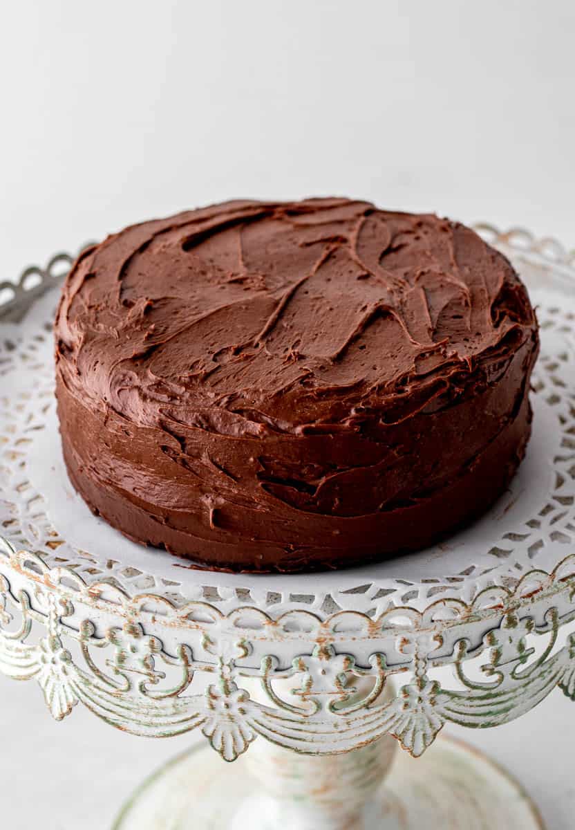 The sugar free chocolate cake frosted on a stand.