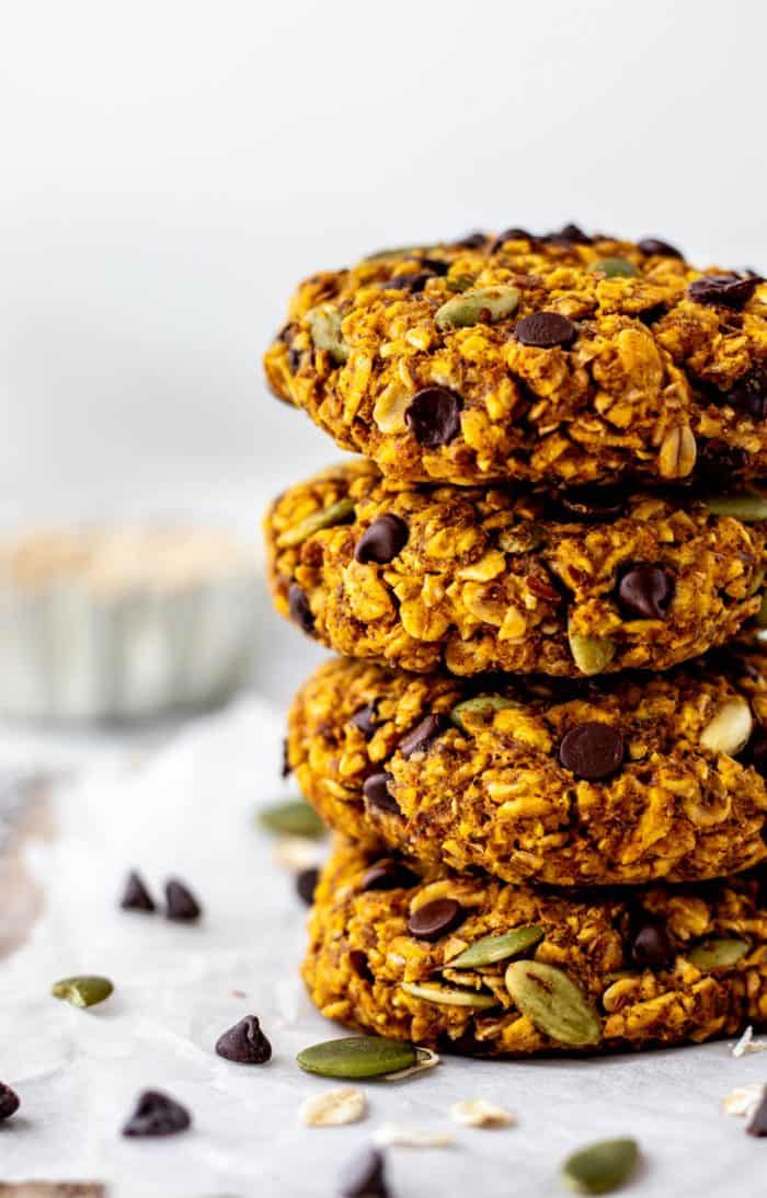 Close up image of a stack of four soft pumpkin breakfast cookies.