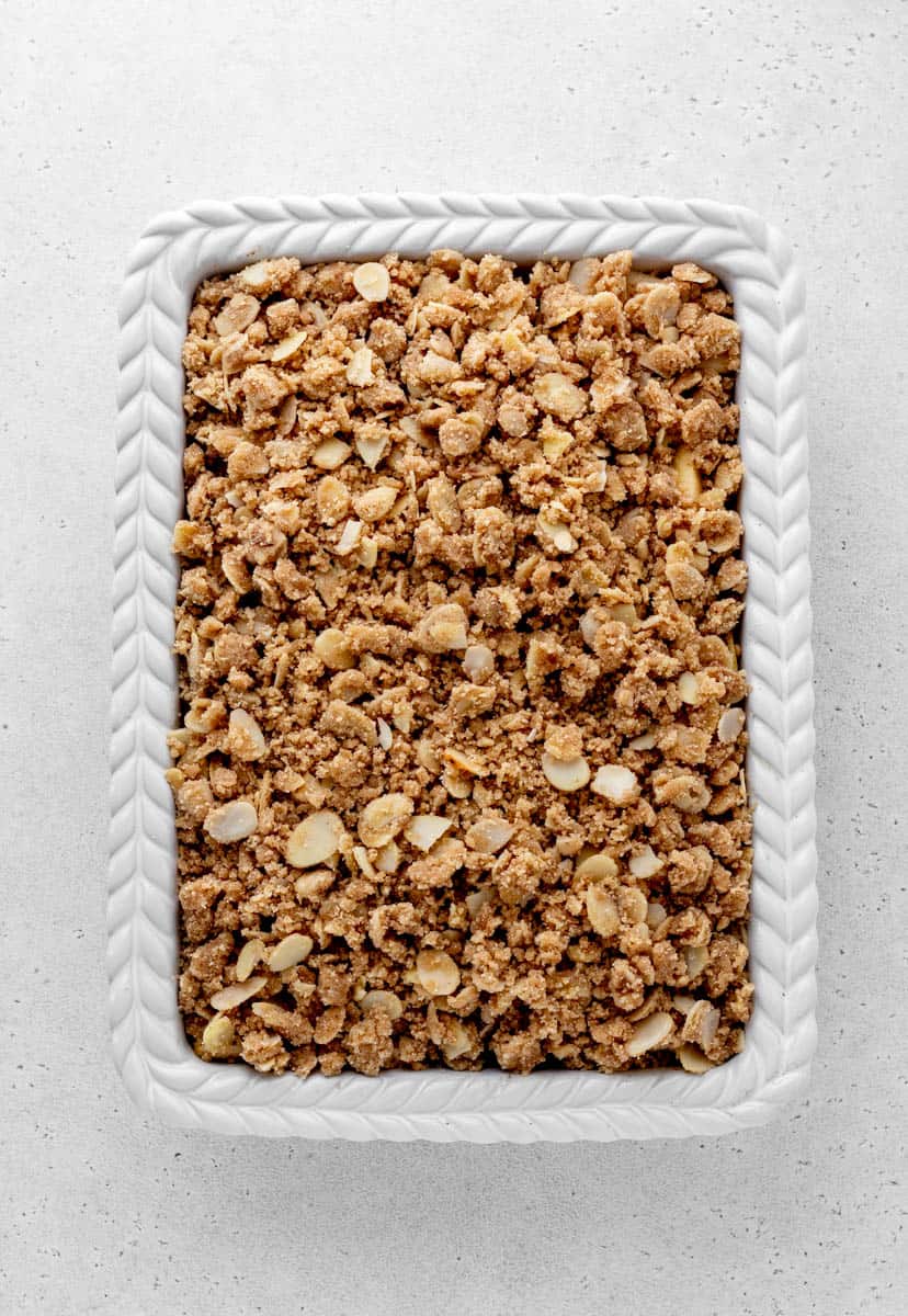 Apple crisp without oats in a white baking dish ready to be baked.