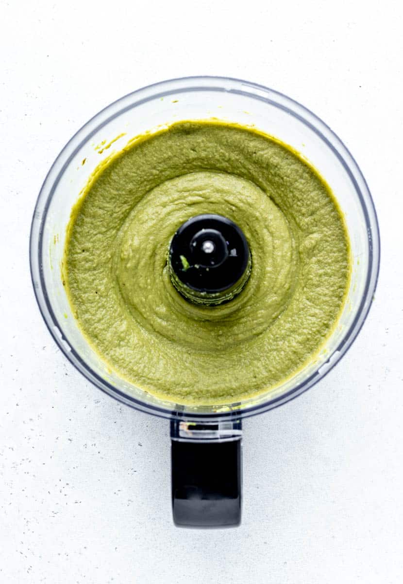 Overhead image of blended avocados in a food processor.