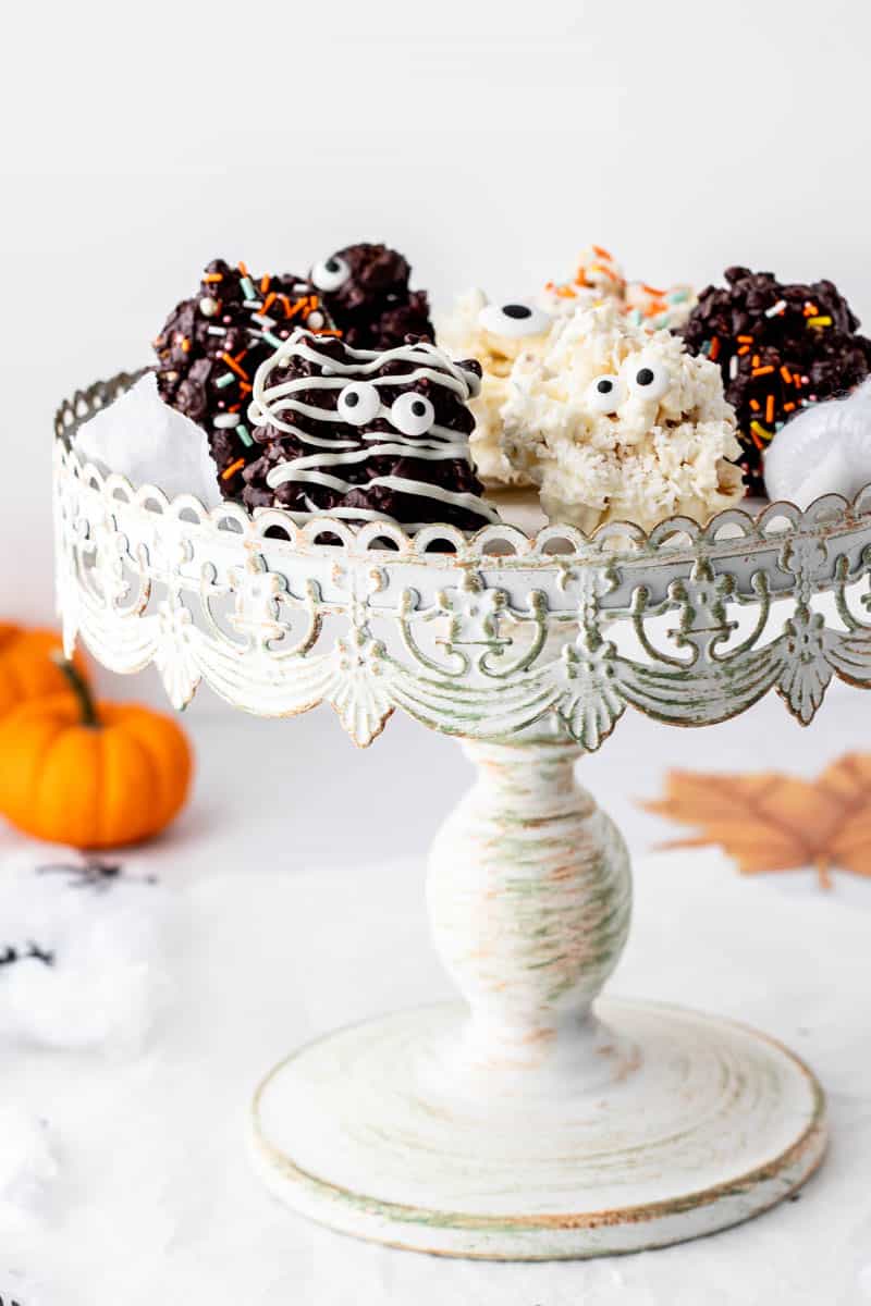 A cake stand with an assortment of Halloween popcorn balls.