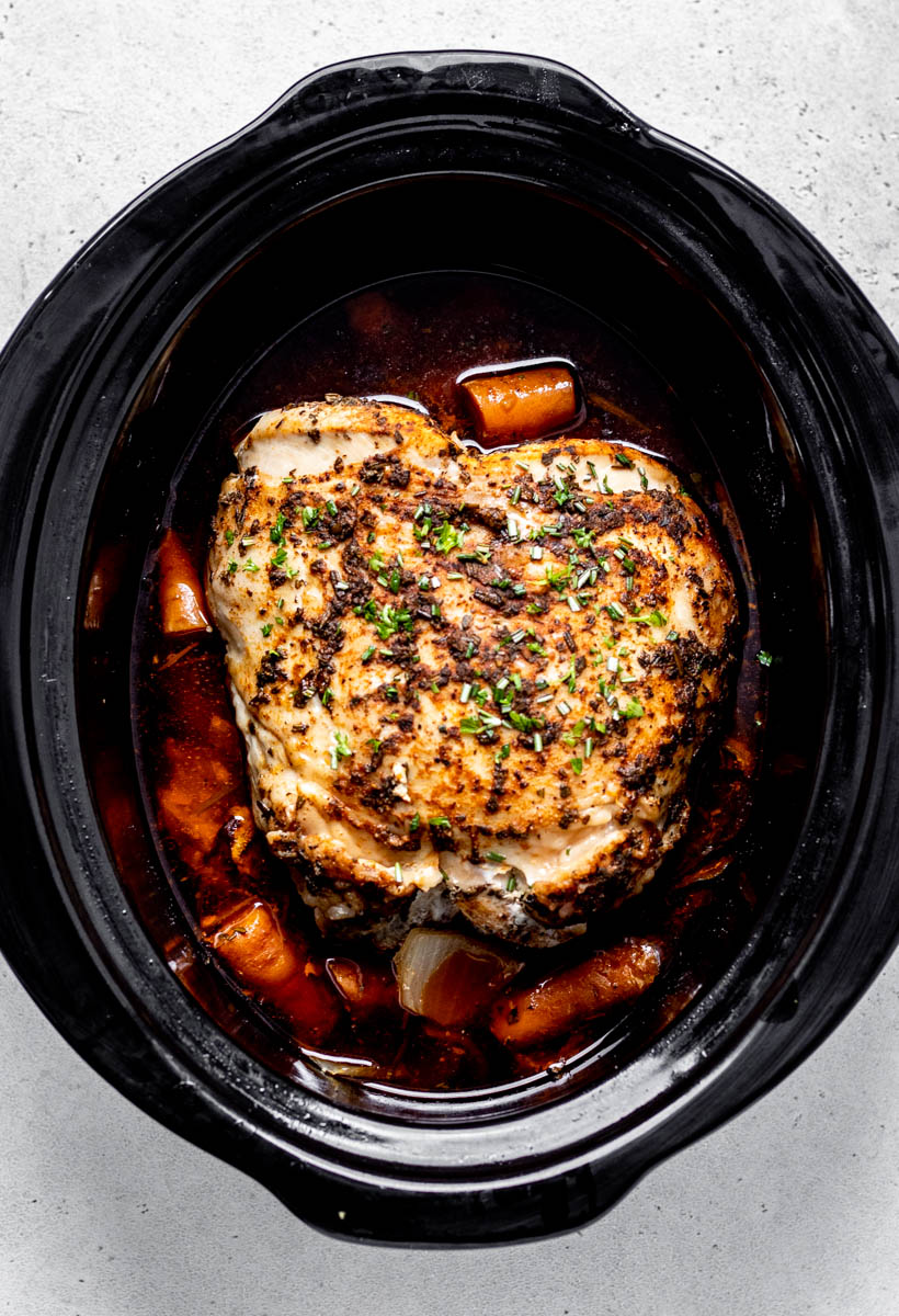 Cooked boneless turkey breast roasted in a slow cooker.