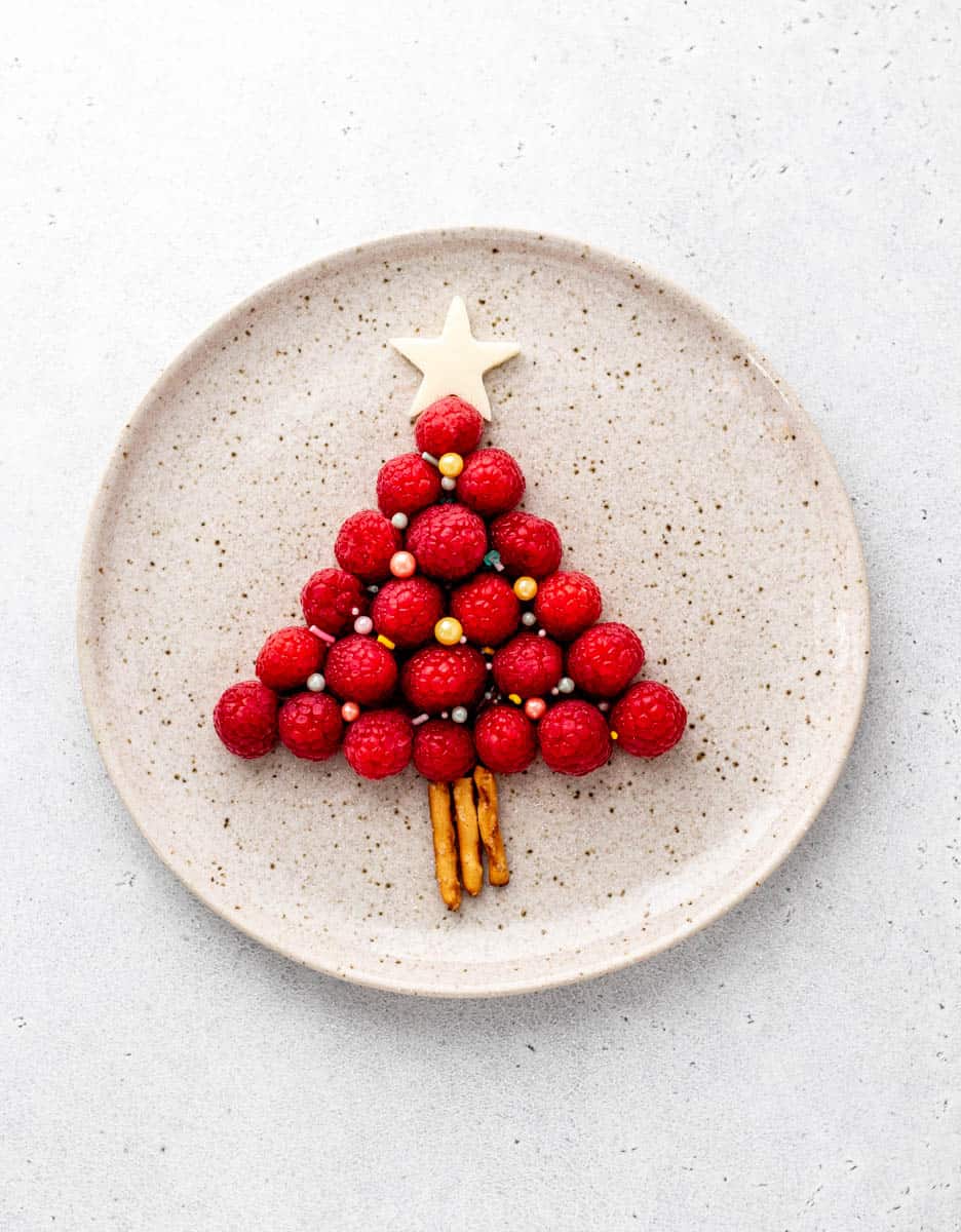 Raspberry Christmas tree on a speckled plate.
