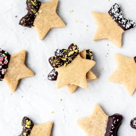 Chocolate dipped 3-ingredient almond flour cookies, sprinkled with pistachios, sea salt, coconut or crushed candy canes.