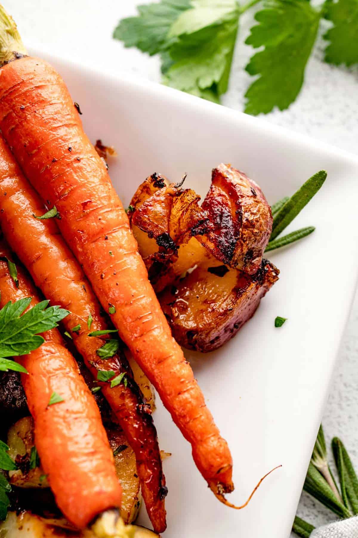 A close up of roasted carrots and potatoes.