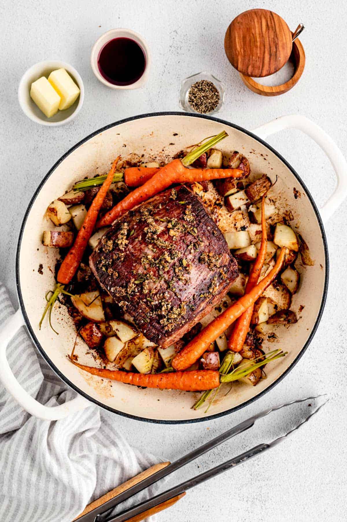The roasted eye of round roast in the pot with carrots and potatoes.