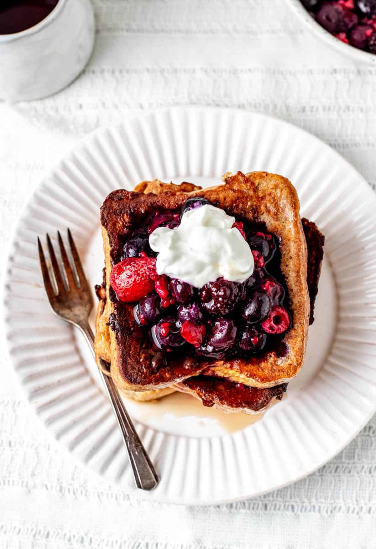 A top down view of high protein French toast on a white plate.