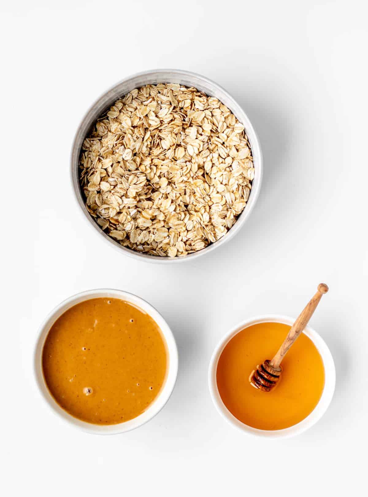Ingredients required for the 3-ingredient peanut butter oatmeal balls on a white background.