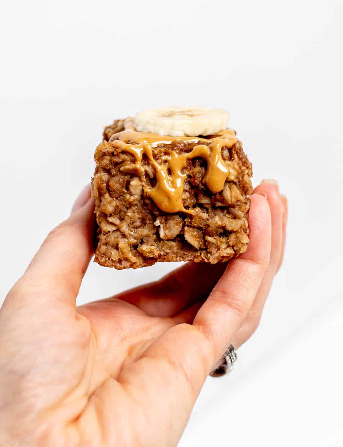 A hand holding up a 3 ingredient banana oatmeal bar.