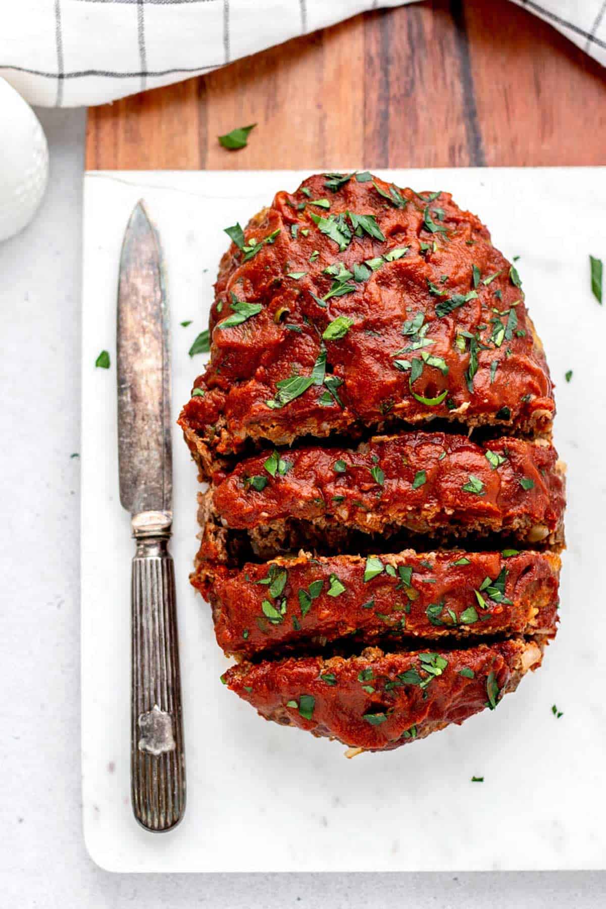 A sliced meatloaf on a cutting board.