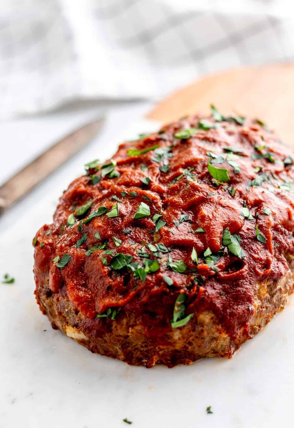 Baked meatloaf on a cutting board.