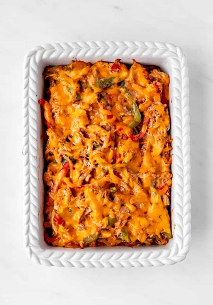A 9x13 casserole dish of baked low carb chicken fajita casserole.