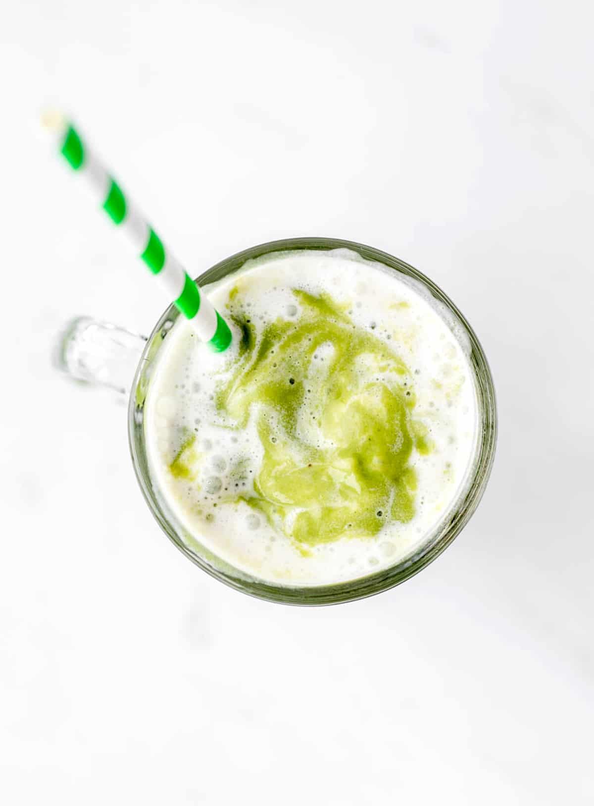 An overhead shot of the healthy shamrock shake in a glass with a straw.