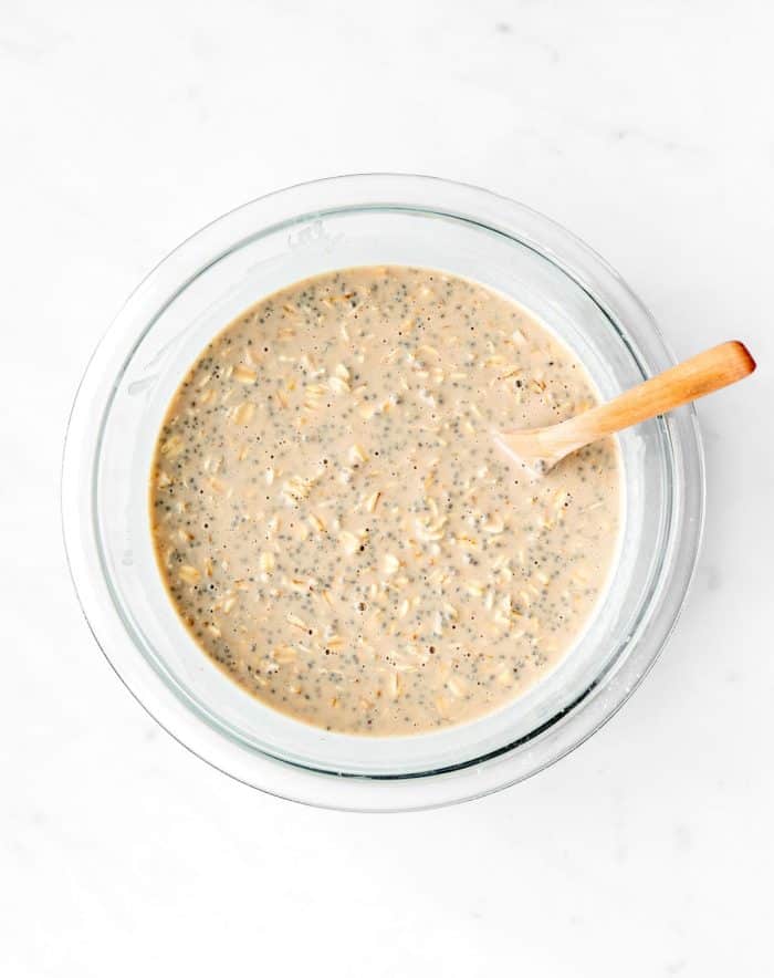 The ingredients for the overnight oats stirred together in a bowl.