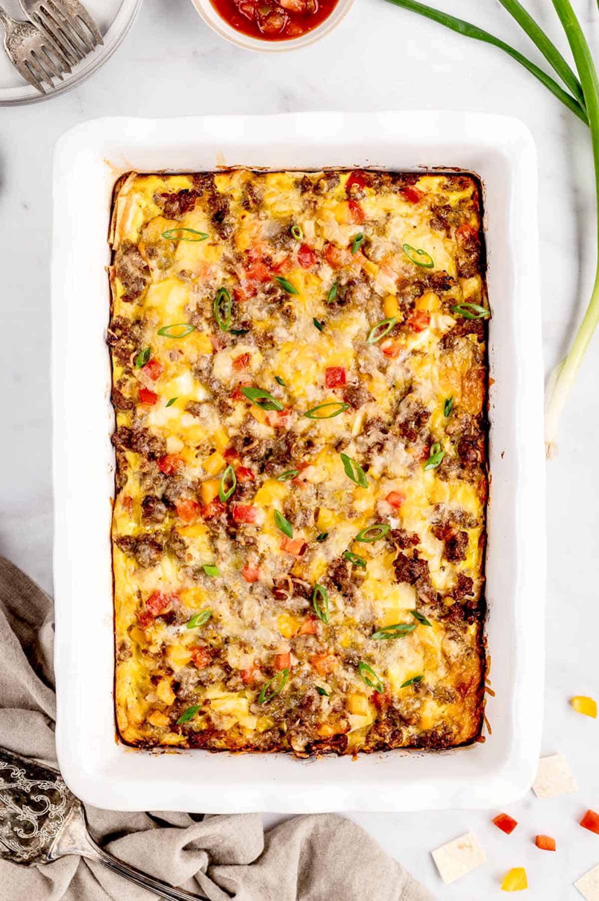 The baked breakfast burrito casserole in a baking dish ready to be served.