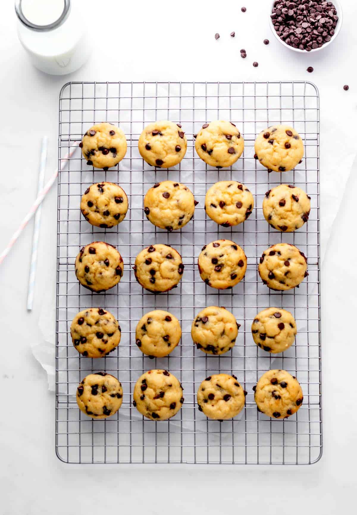 Mini chocolate chip muffins on a wire rack.