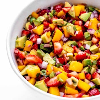 Strawberry mango salsa in a large white bowl.