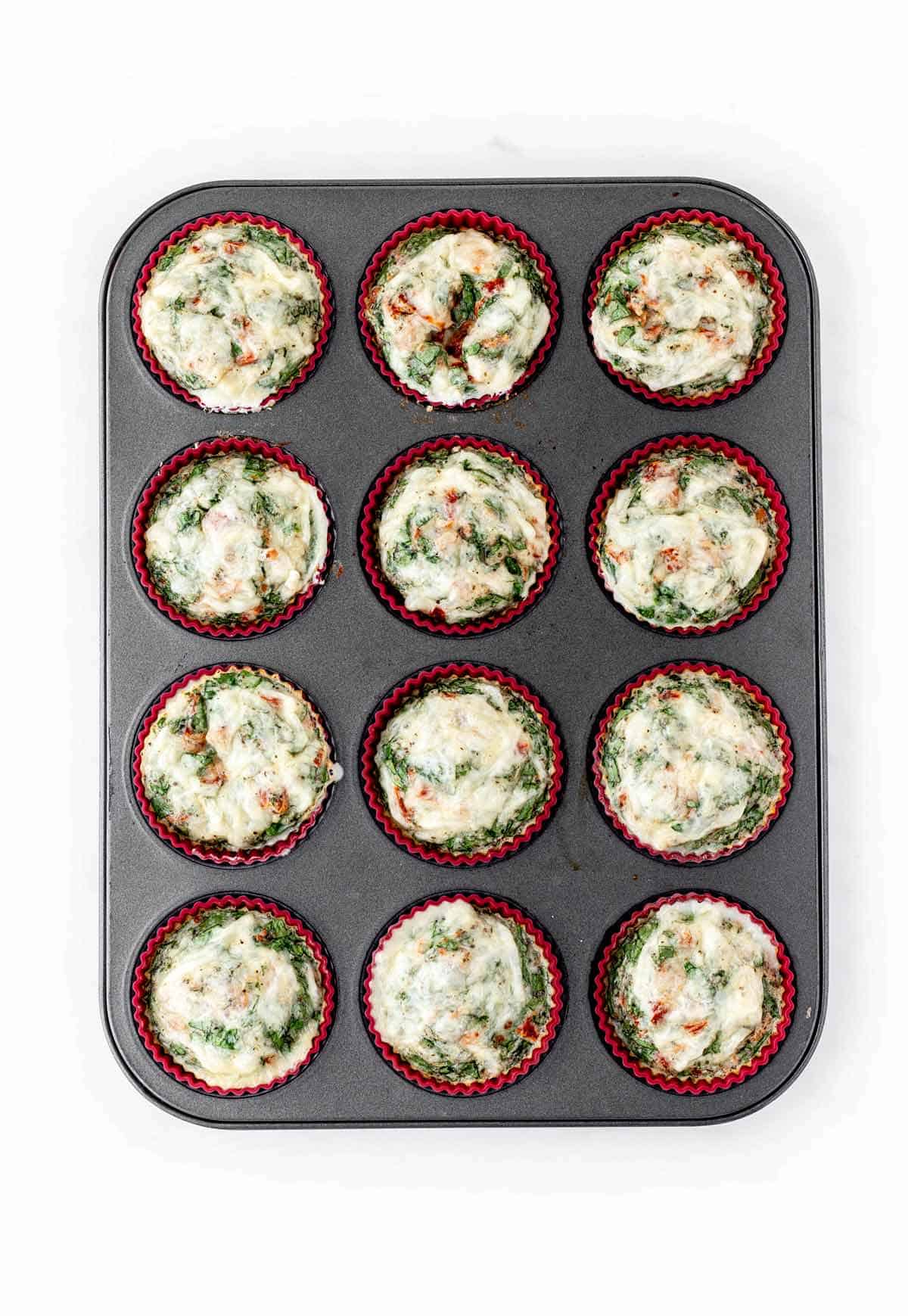 Baked egg white bites in a muffin tin.