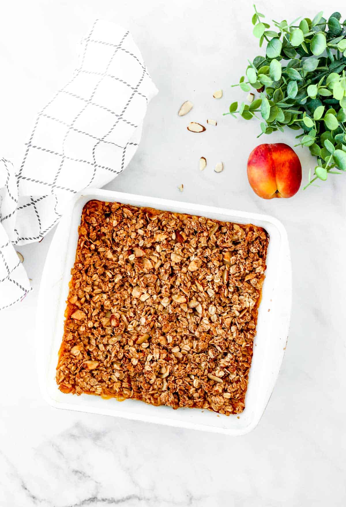 Easy peach crisp with oatmeal topping in a baking dish.