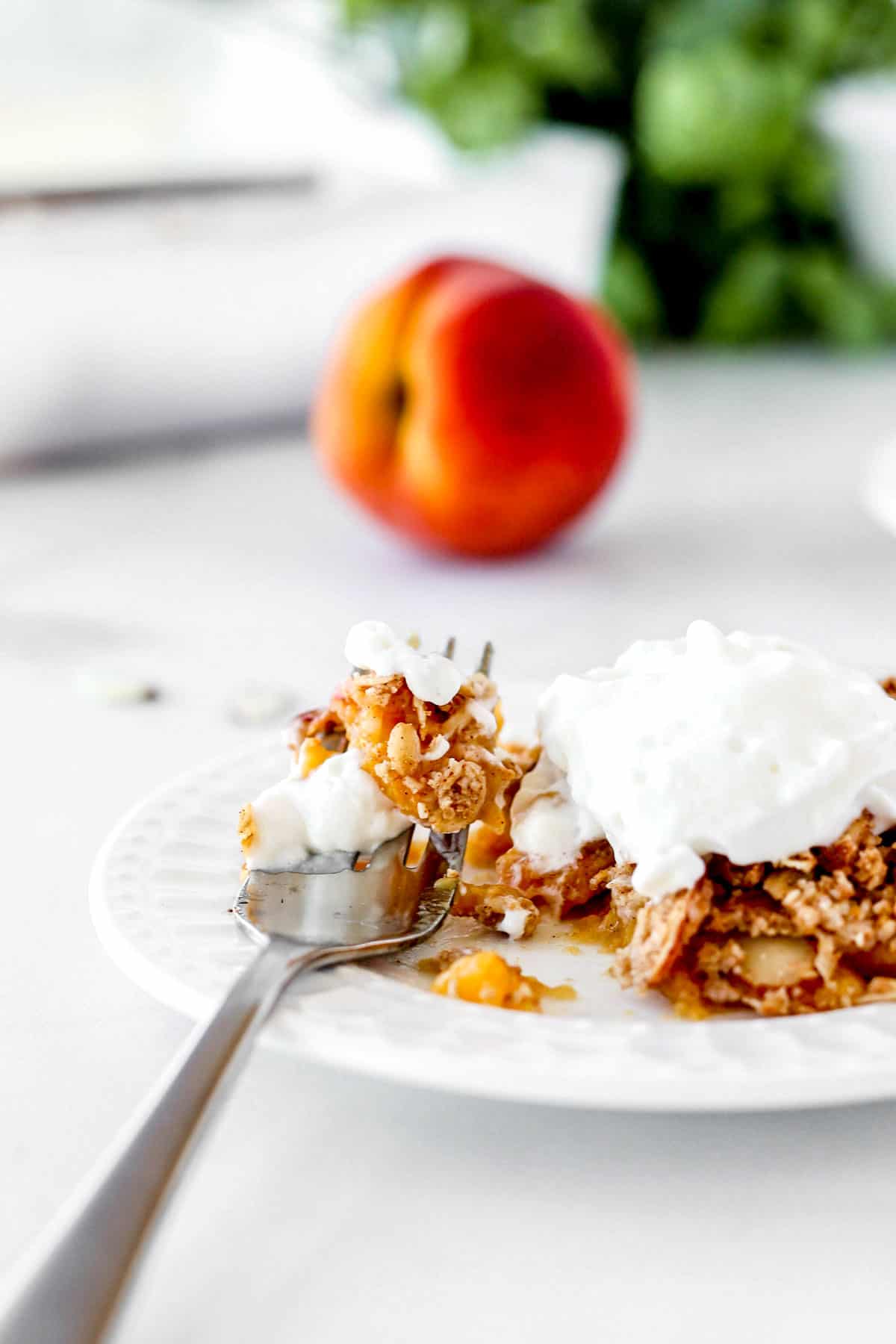 A fork with some low sugar peach crisp on it.