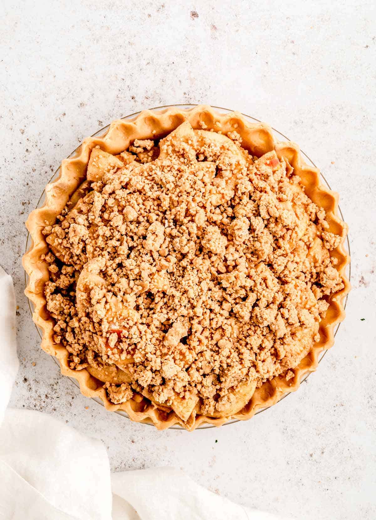 No top crust apple pie in a pie dish.