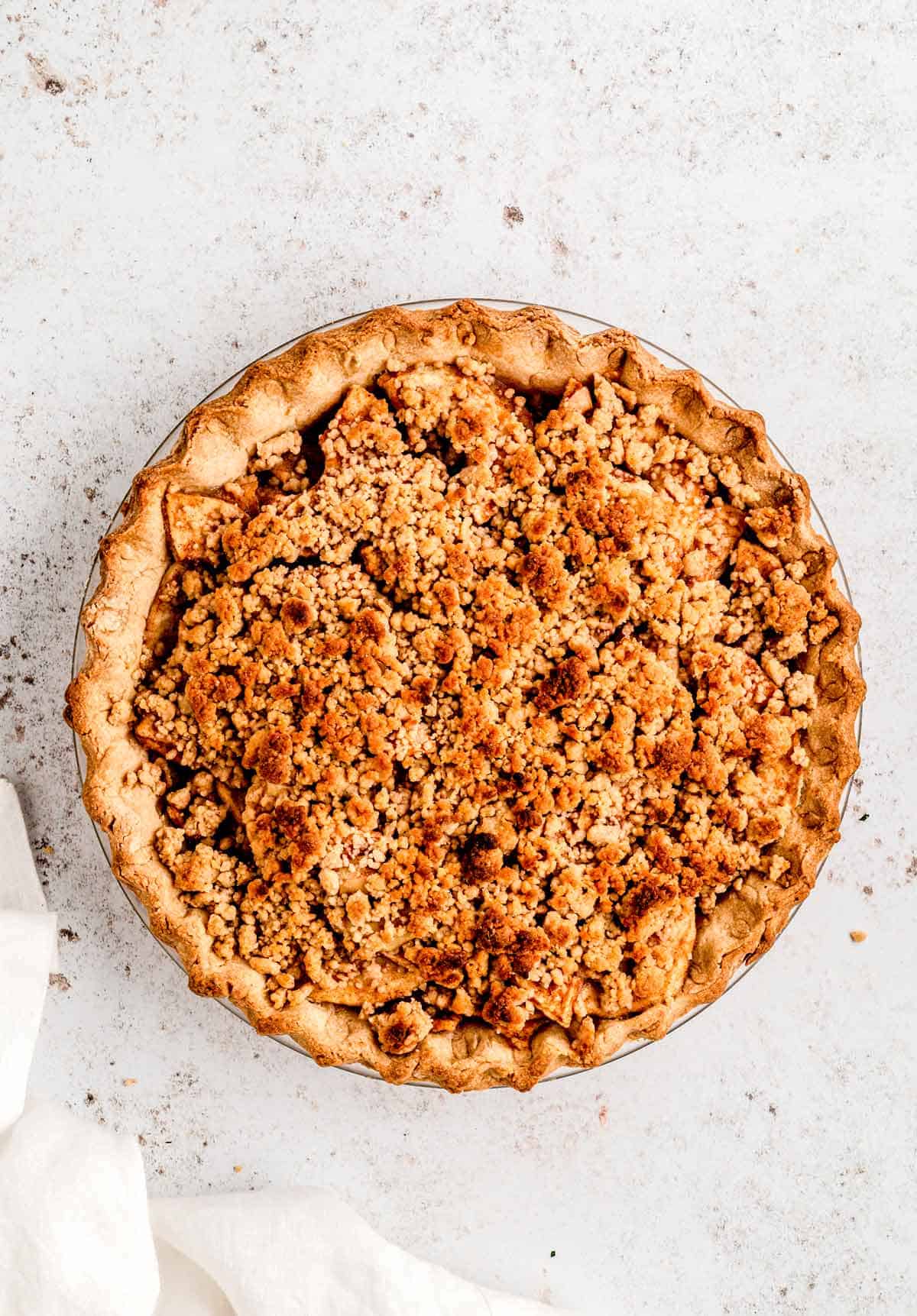 Healthy apple crumble pie in a pie dish.