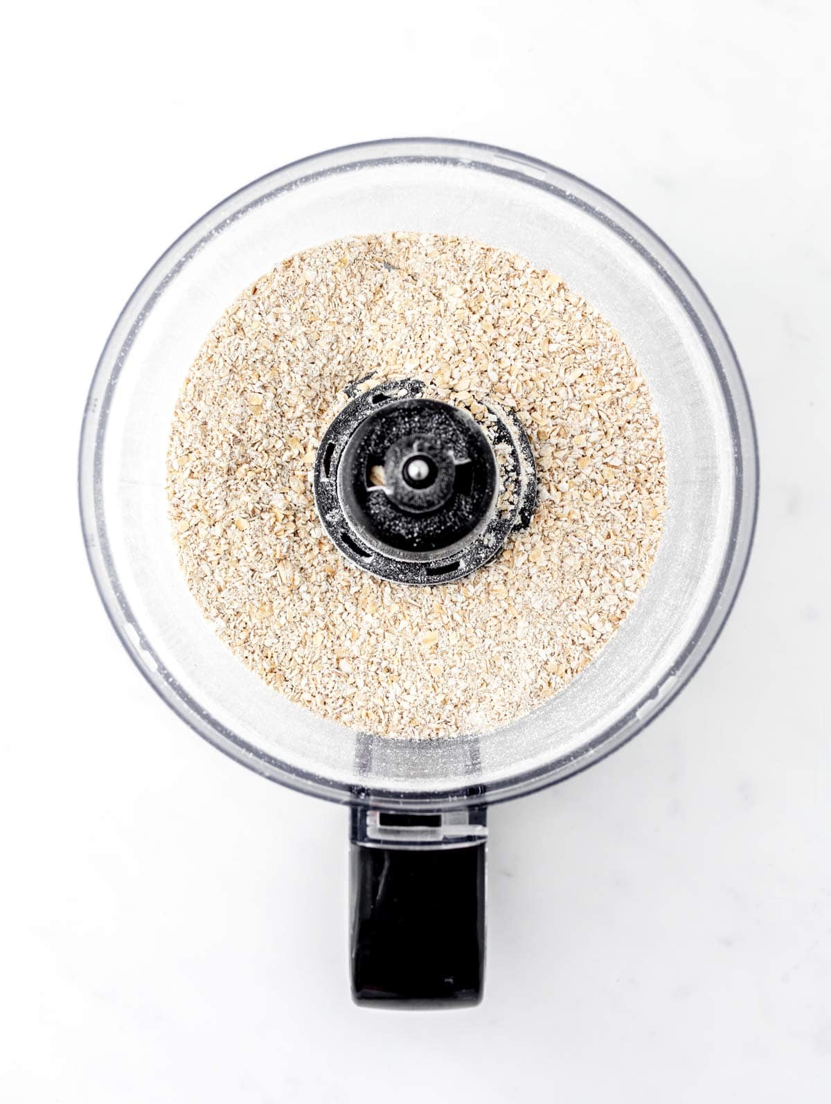 Oats ground up into oat flour in a food processor.