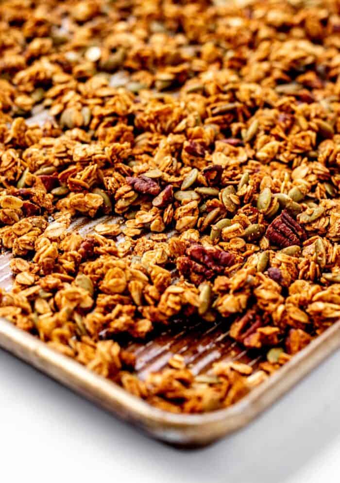 Up close image of pumpkin and flax seed granola on a baking sheet.
