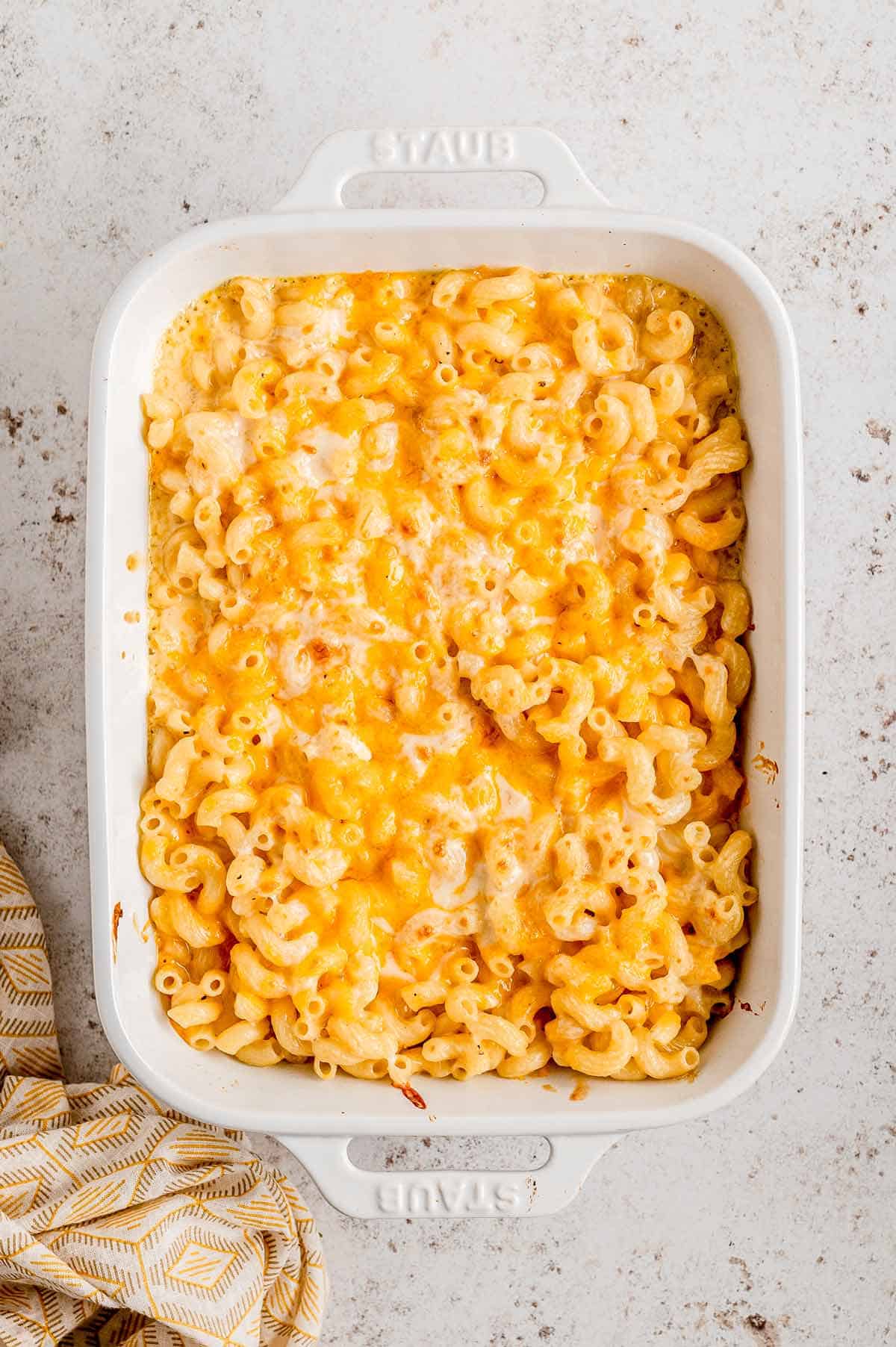 Mac and cheese without flour in a casserole dish with melted cheese on top.