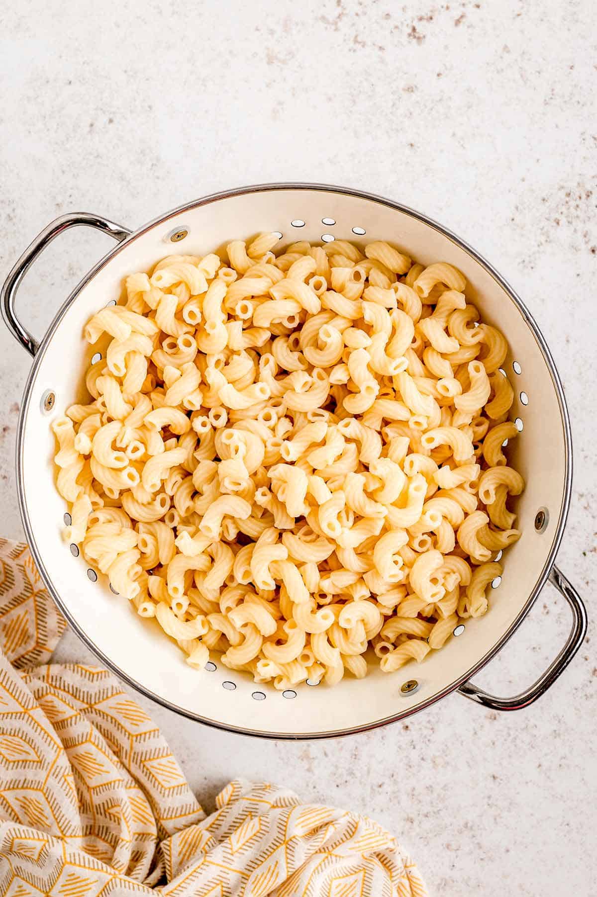 Cooked elbow macaroni noodles in a pot.