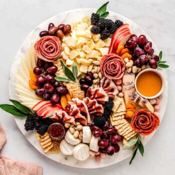 The ultimate charcuterie board displayed on a round board.