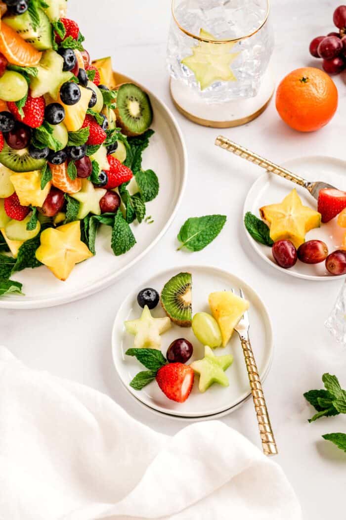 Fruit from the Christmas fruit tray on some plates.